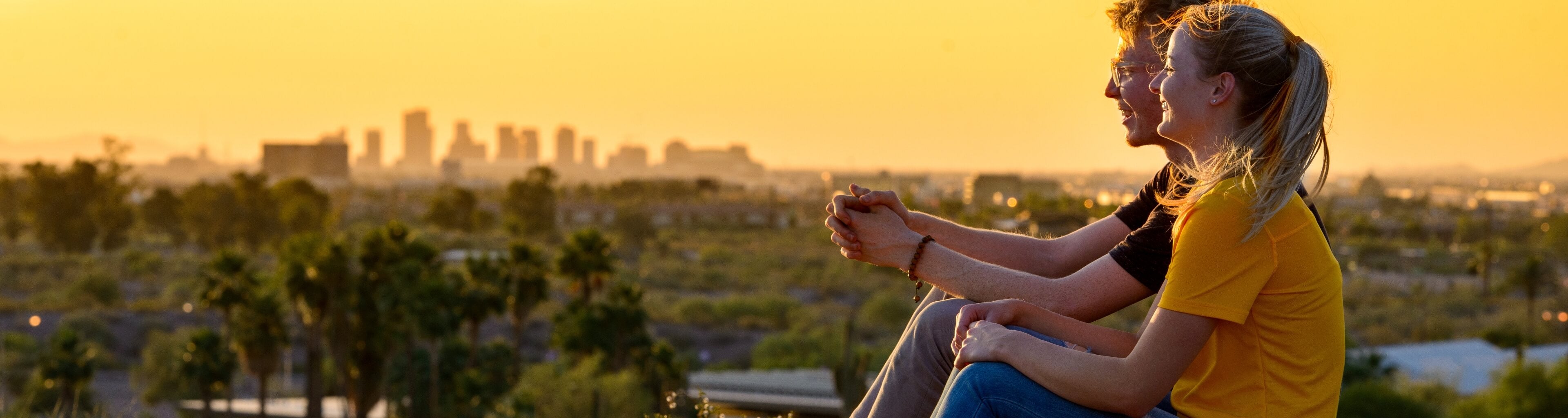 Students looking at city at the sunset