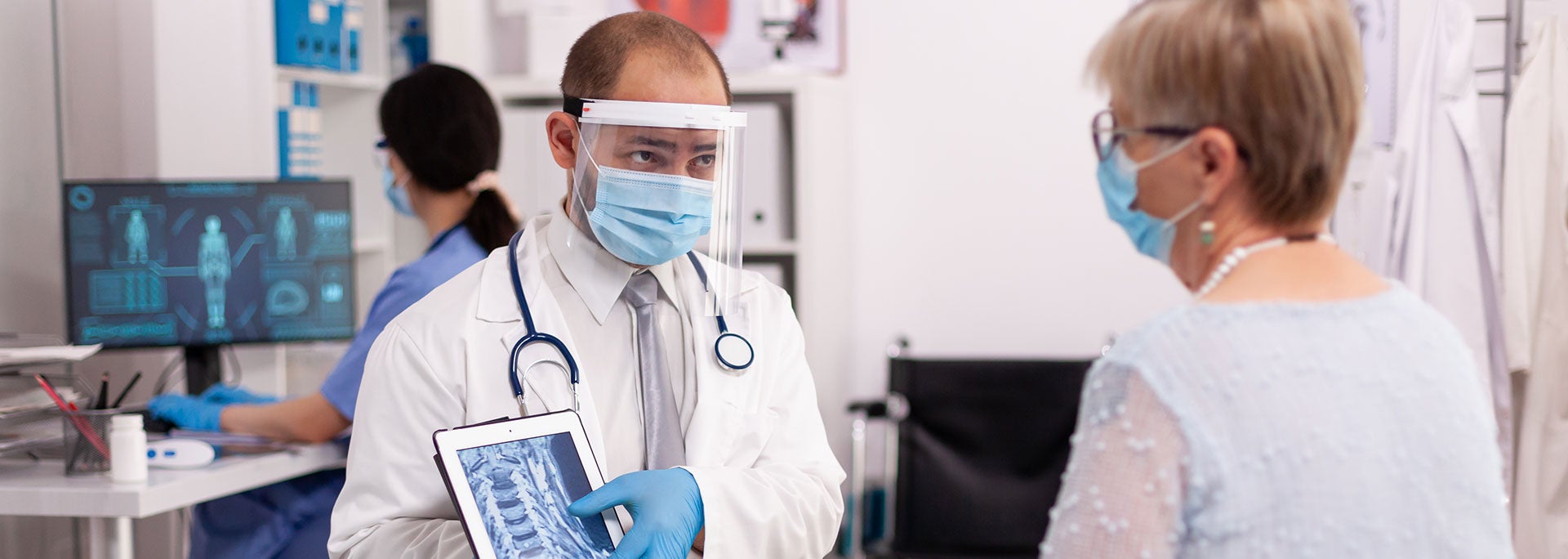 Doctor showing patient xray on a tablet