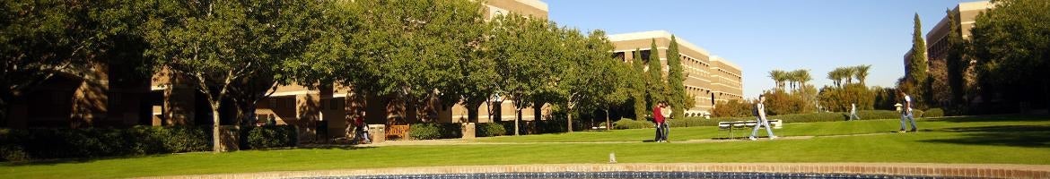 An open grassy area in front of a building on West Campus