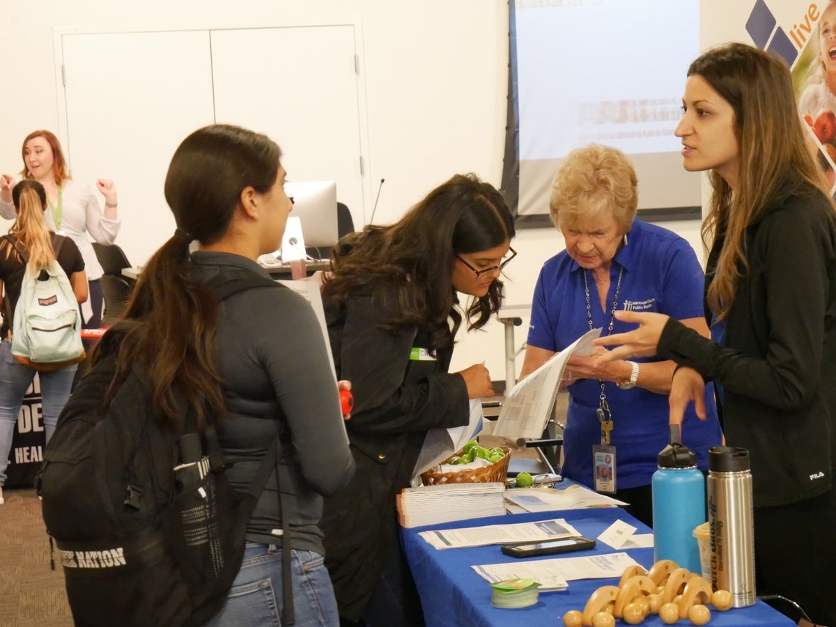 Students talking to potential employer