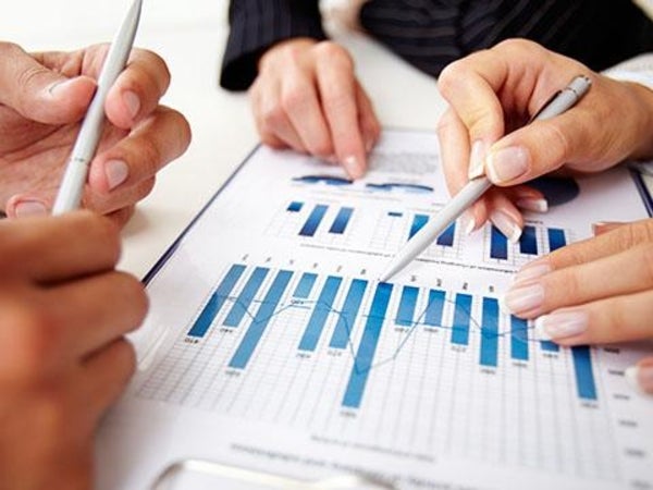 graph chart with hands pointing at graph figures